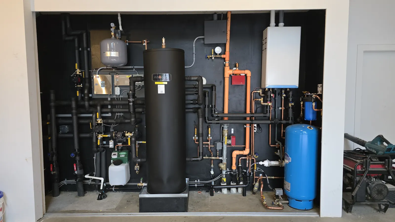 Full black mechanical wall with Argosy buffer tank, IBC boiler and blue pressure tank