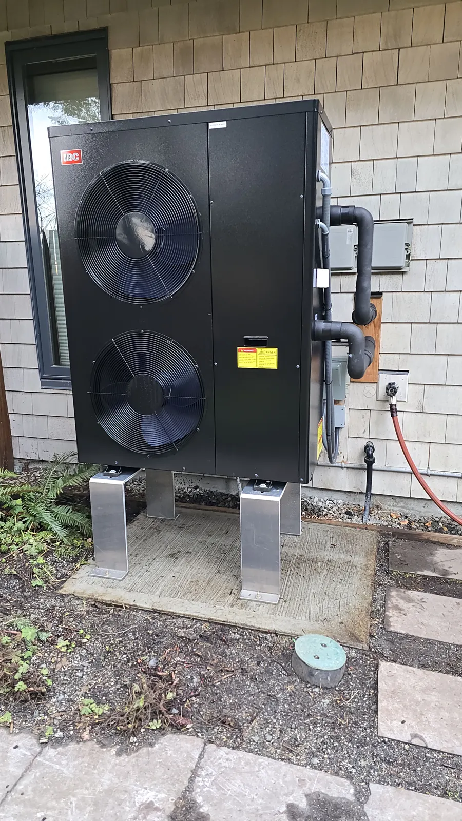 After: outdoor heat pump unit installed outside the home