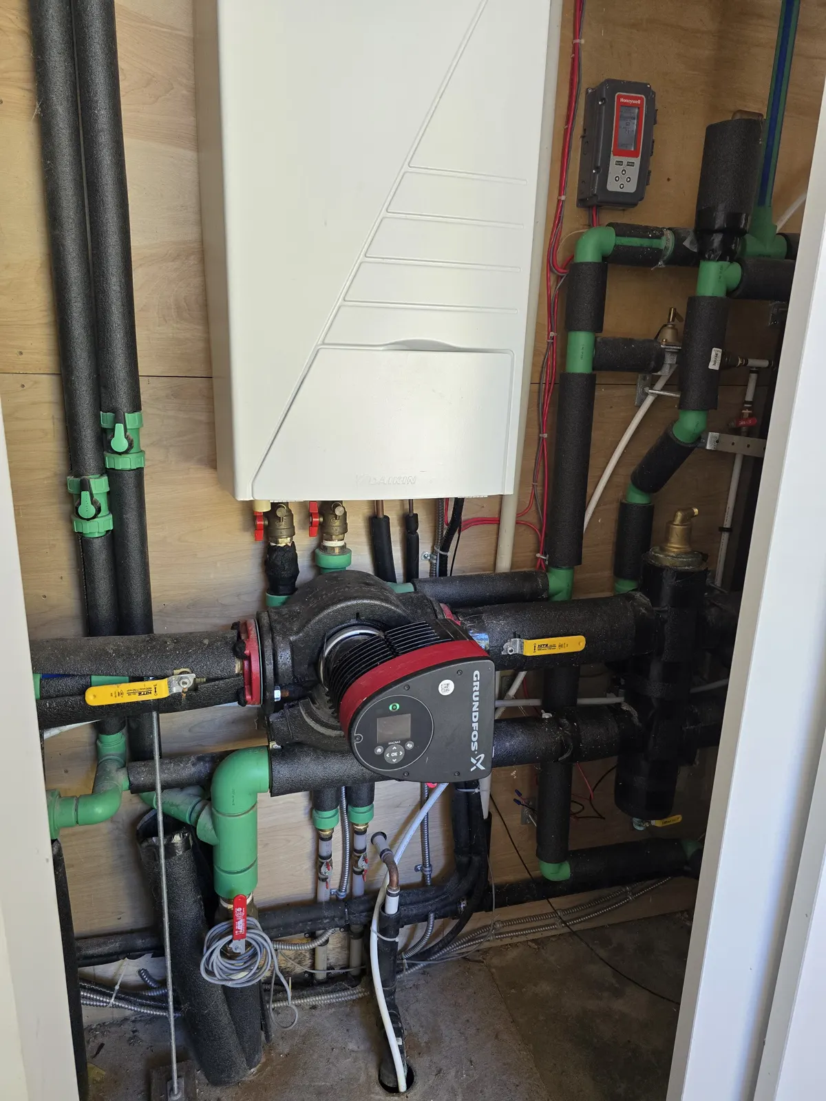 Before: Daikin Altherma indoor unit with a Grundfos pump and green PP-R piping