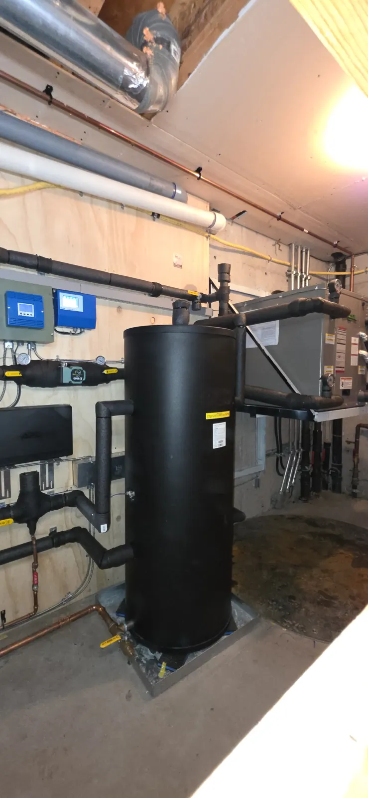 After: black buffer tank with insulated piping and controls