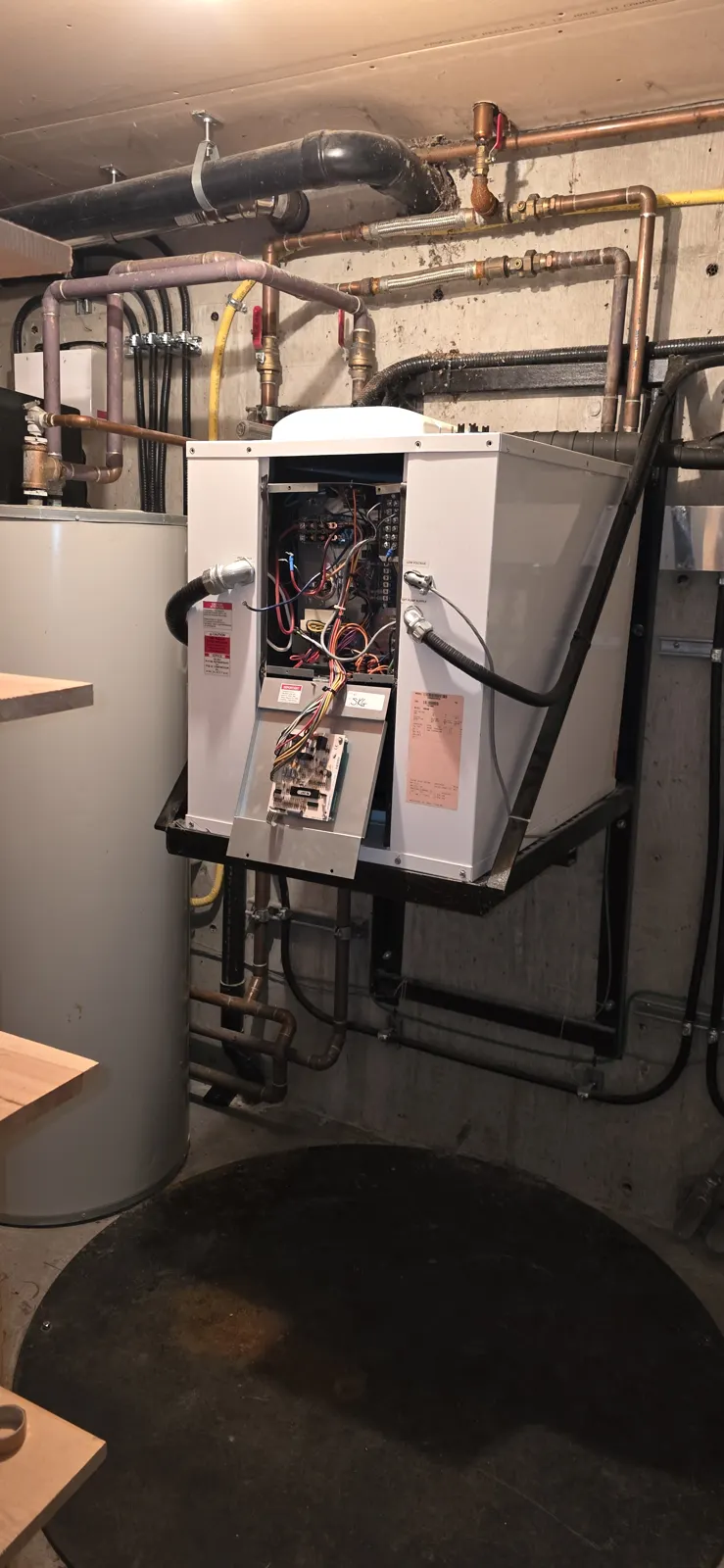 Before: the original heating equipment with its front cover off