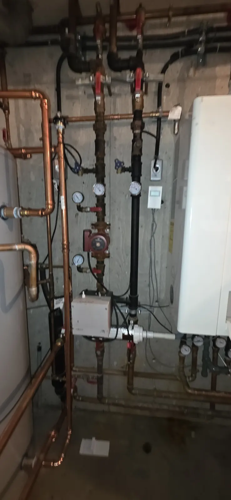 Before: old copper piping and valves in the mechanical room