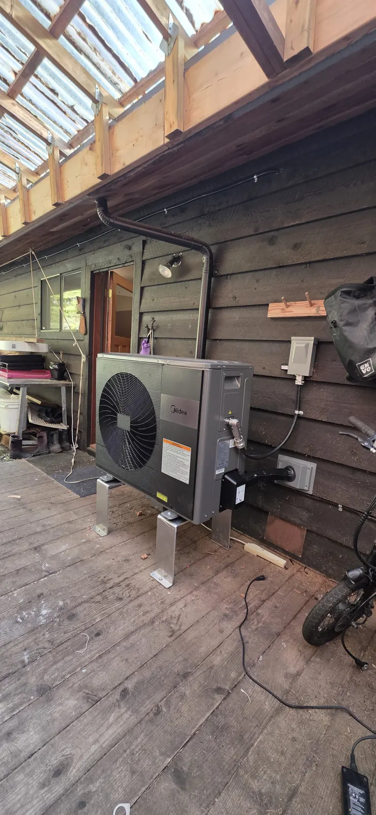 After: Midea outdoor heat pump unit on stands on the deck