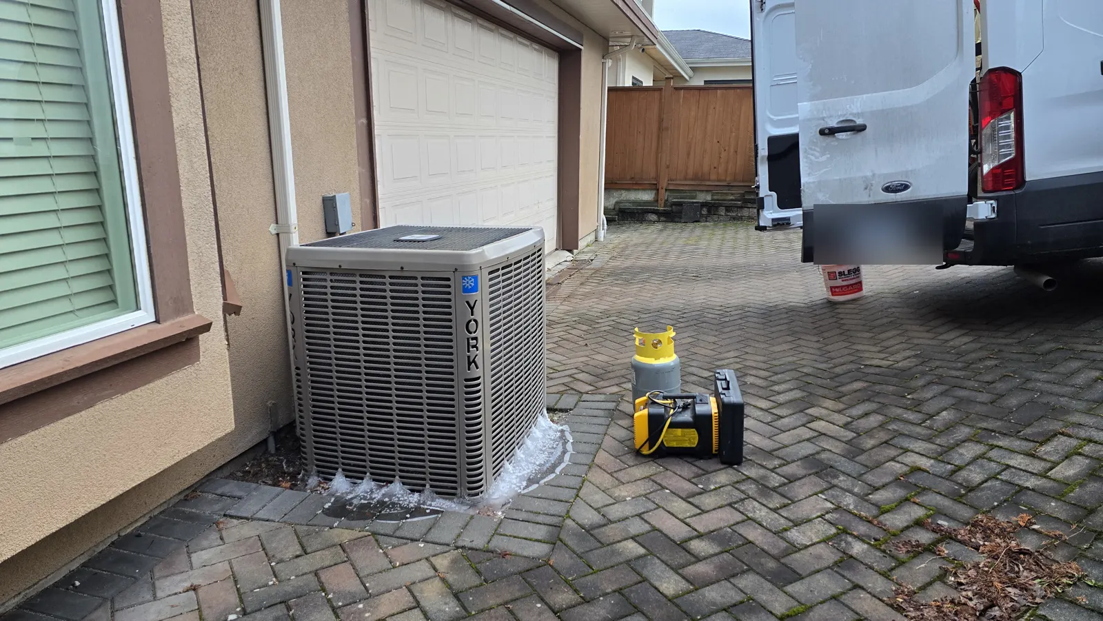 Before: the York outdoor unit on the driveway, with recovery equipment and the Zencore van